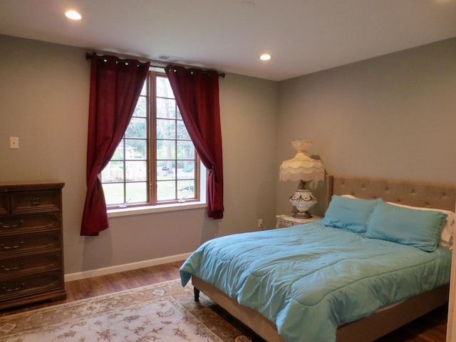 bedroom with recessed lighting, baseboards, multiple windows, and wood finished floors