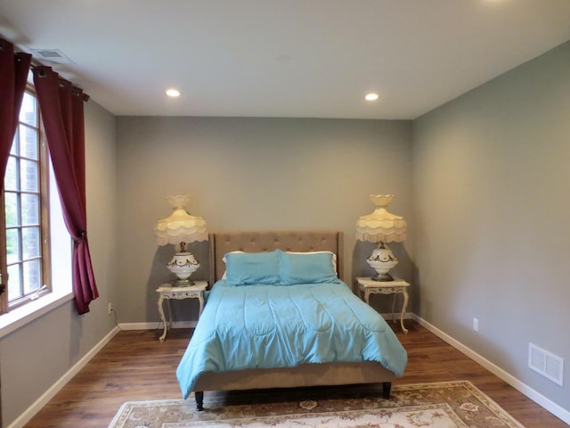 bedroom with visible vents, recessed lighting, baseboards, and wood finished floors