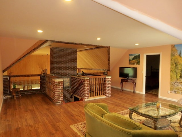 interior space featuring recessed lighting, baseboards, wood finished floors, and a fireplace