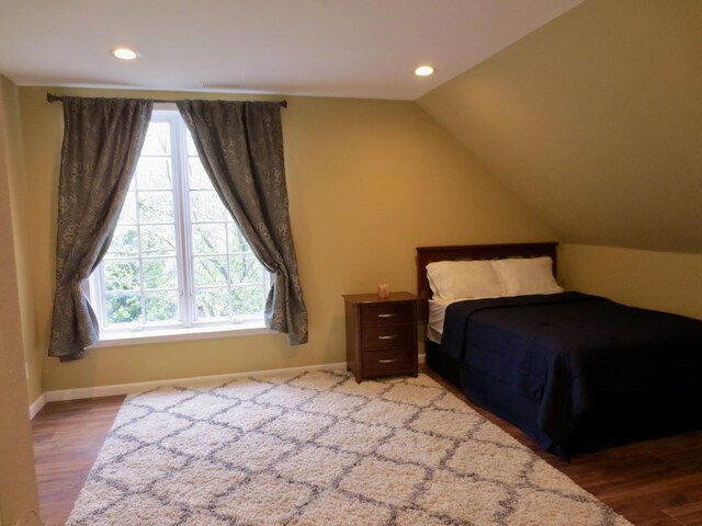 bedroom with baseboards, multiple windows, recessed lighting, and wood finished floors