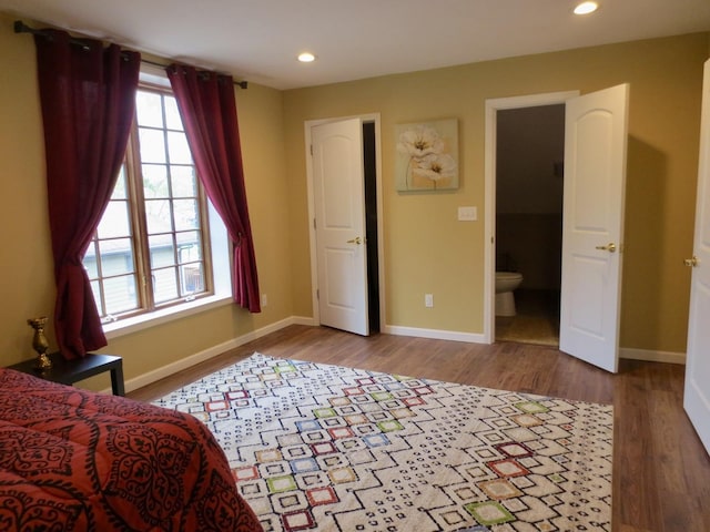 bedroom featuring connected bathroom, recessed lighting, baseboards, and wood finished floors