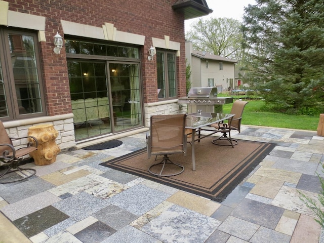 view of patio featuring outdoor dining area and a grill