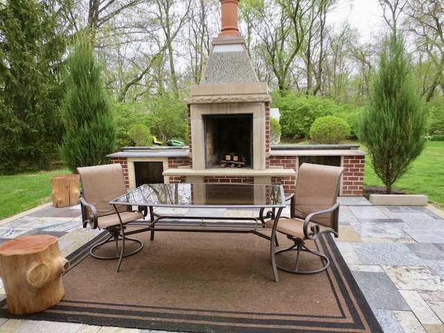 view of patio / terrace featuring an outdoor brick fireplace