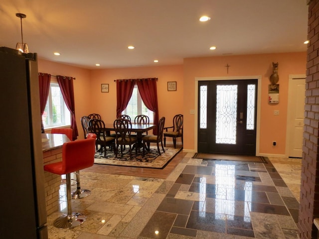 foyer with baseboards and recessed lighting
