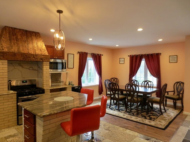 dining room featuring plenty of natural light, recessed lighting, and baseboards
