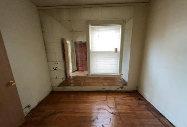 empty room featuring baseboards and wood finished floors
