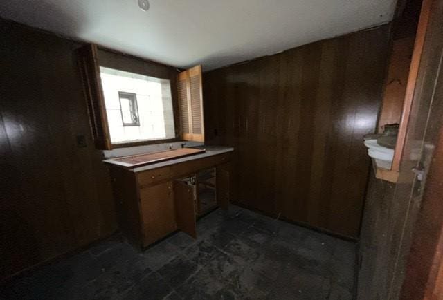 bathroom with wood walls