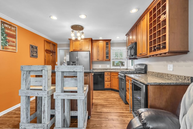 3010 Mary Ln, Mchenry, IL 60051 - kitchen with brown cabinets, beverage cooler, ornamental molding, and black appliances