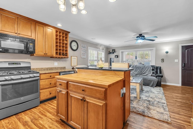 3010 Mary Ln, Mchenry, IL 60051 - kitchen featuring crown molding, wood counters, black microwave, and gas range