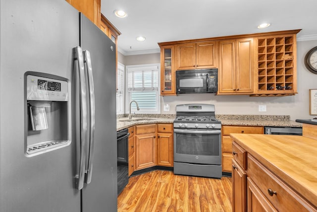 3010 Mary Ln, Mchenry, IL 60051 - kitchen with brown cabinetry, crown molding, appliances with stainless steel finishes, a sink, and light wood finished floors