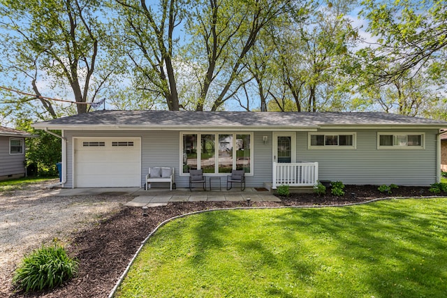 310 S Elm St, Saint Joseph, IL 61873 - ranch-style home featuring a garage, dirt driveway, a front lawn, and a porch