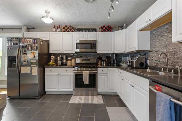 310 S Elm St, Saint Joseph, IL 61873 - kitchen with stainless steel appliances, dark countertops, decorative backsplash, and a sink