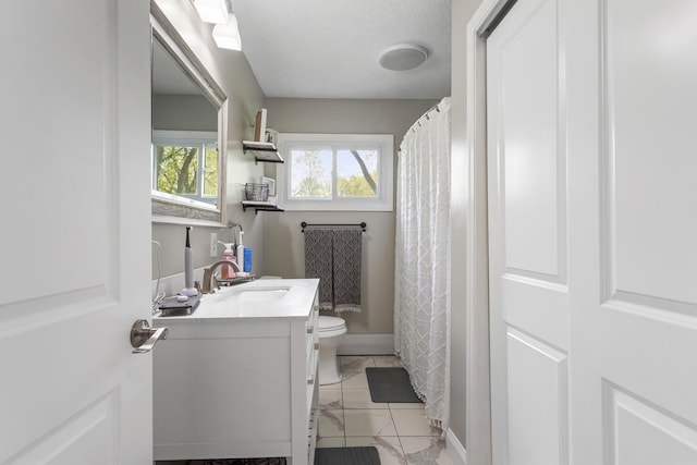 310 S Elm St, Saint Joseph, IL 61873 - bathroom featuring toilet, baseboards, marble finish floor, and vanity