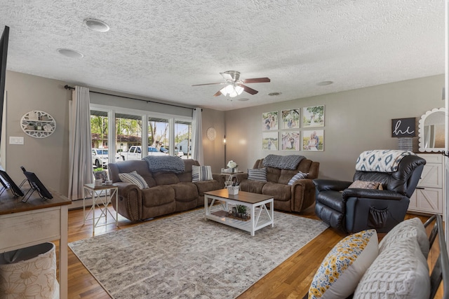 310 S Elm St, Saint Joseph, IL 61873 - living area with a textured ceiling, a ceiling fan, a baseboard heating unit, and wood finished floors