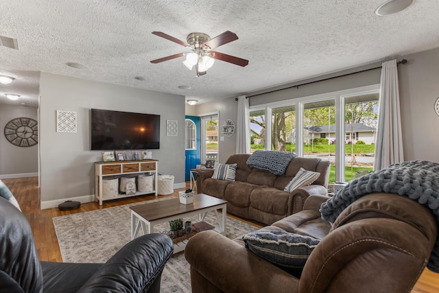 310 S Elm St, Saint Joseph, IL 61873 - living area with baseboards, a ceiling fan, a textured ceiling, and wood finished floors