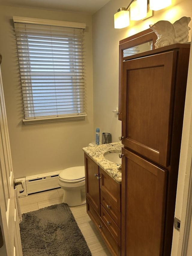 7172 W Armitage Ave, Chicago, IL 60707 - half bath with vanity, baseboard heating, and toilet