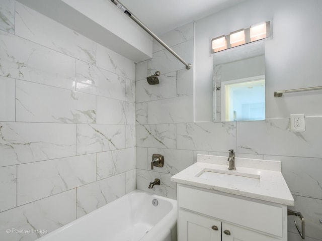 bathroom with shower / tub combination, tile walls, and vanity