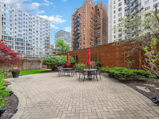 view of patio / terrace featuring fence and outdoor dining space