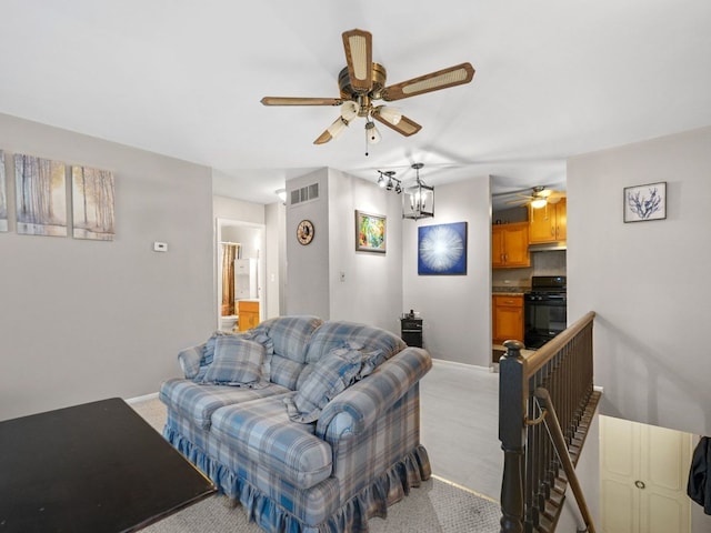 121 Foxhill Ct Unit D, New Lenox, IL 60451 - living area featuring baseboards, ceiling fan with notable chandelier, light colored carpet, and visible vents