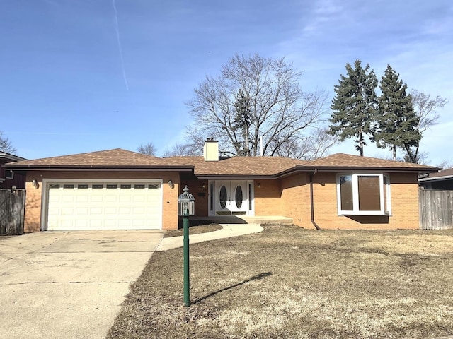 ranch-style home with driveway, a chimney, brick siding, fence, and an attached garage