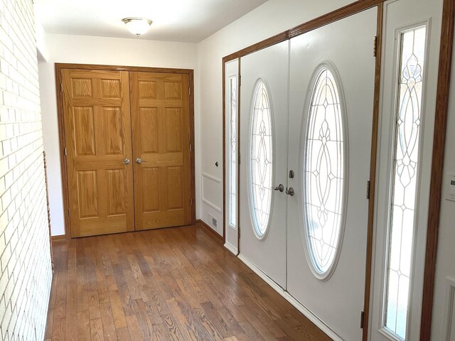 unfurnished dining area featuring wood-type flooring, visible vents, and plenty of natural light