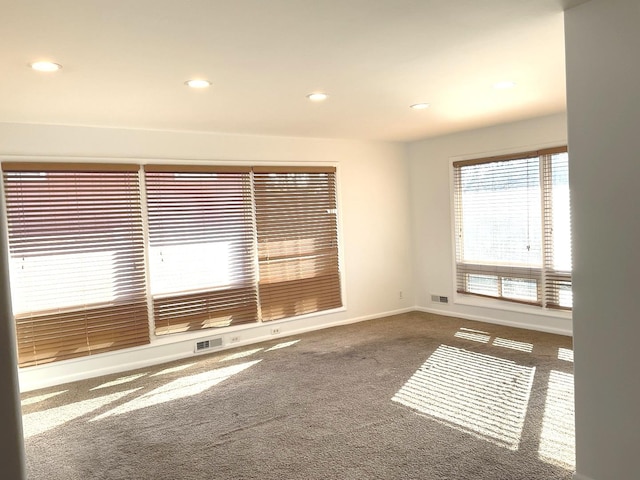 carpeted empty room with recessed lighting, baseboards, and visible vents