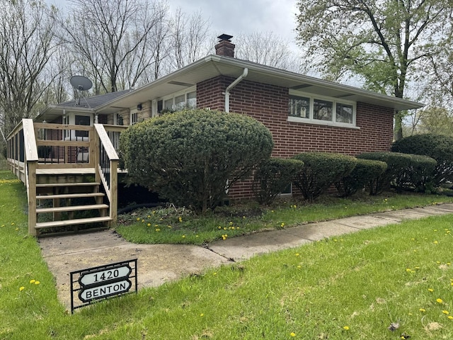 view of property exterior with stairway, brick siding, a chimney, and a wooden deck