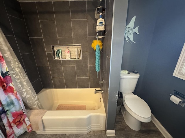 full bath with baseboards, shower / bath combo, and toilet