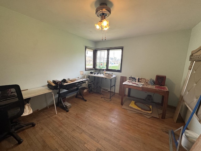 office space with a ceiling fan and wood finished floors