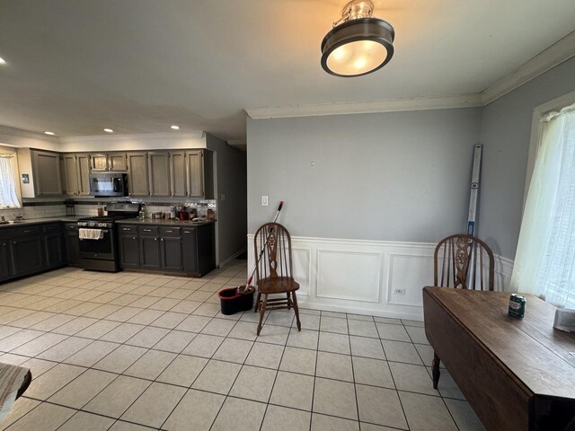 kitchen with stainless steel appliances, recessed lighting, decorative backsplash, light tile patterned floors, and ornamental molding