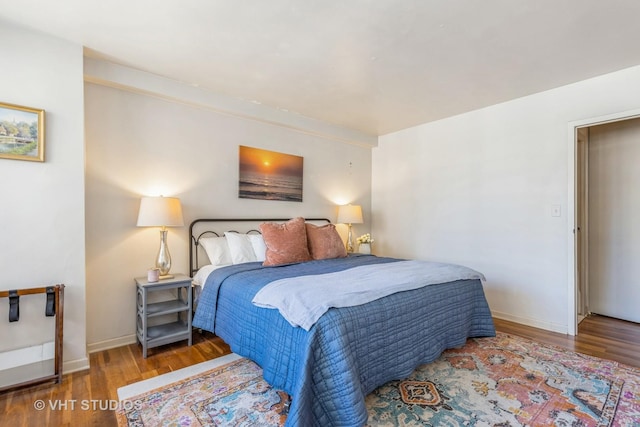 bedroom with wood finished floors and baseboards