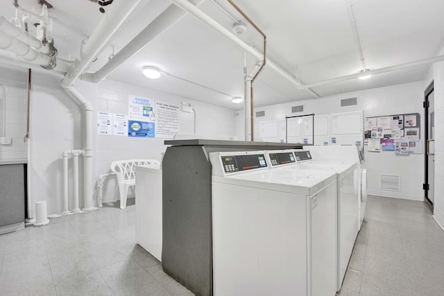 shared laundry featuring separate washer and dryer