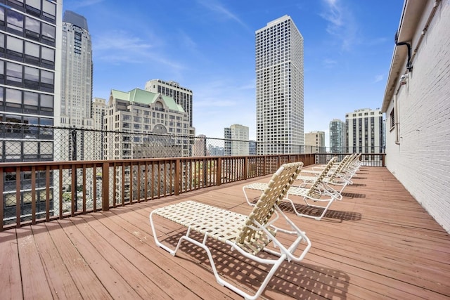 wooden terrace featuring a view of city