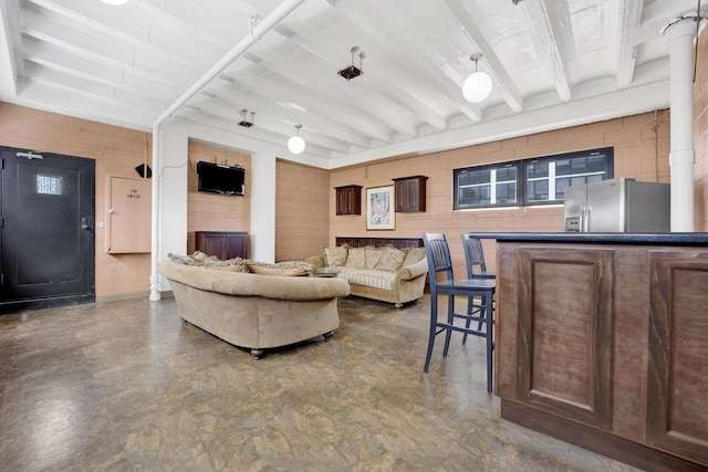living room with beam ceiling