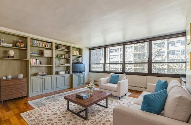 living area with a baseboard radiator and wood finished floors