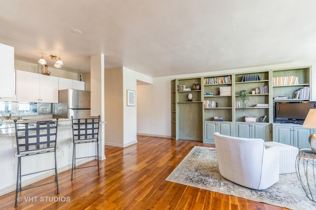 living area with wood finished floors and baseboards