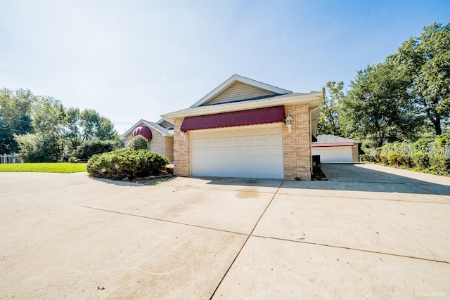 14650 Lamon Ave, Midlothian, IL 60445 - view of property exterior featuring a garage and brick siding