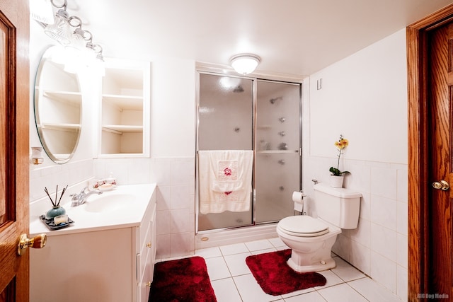 14650 Lamon Ave, Midlothian, IL 60445 - full bath featuring vanity, toilet, tile patterned floors, tile walls, and a stall shower