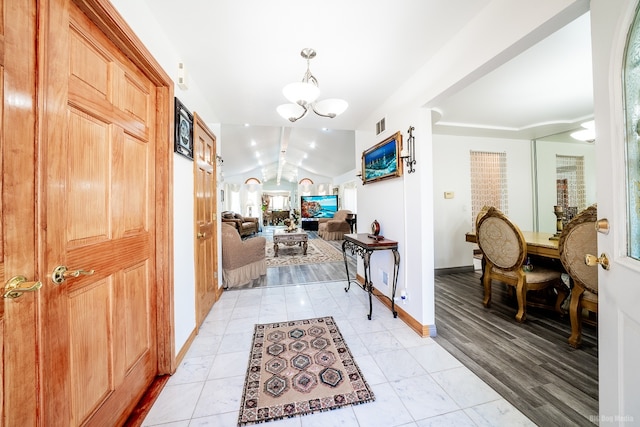 14650 Lamon Ave, Midlothian, IL 60445 - entrance foyer with an inviting chandelier, baseboards, vaulted ceiling, and visible vents