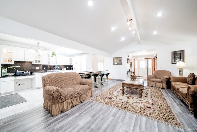 14650 Lamon Ave, Midlothian, IL 60445 - living room featuring an inviting chandelier, lofted ceiling with beams, and light wood finished floors