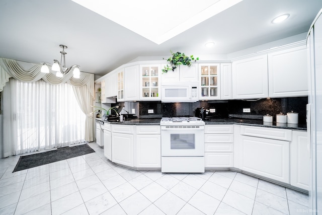 14650 Lamon Ave, Midlothian, IL 60445 - kitchen with dark countertops, decorative backsplash, white appliances, and a chandelier
