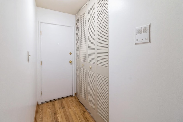 corridor with light wood-style floors