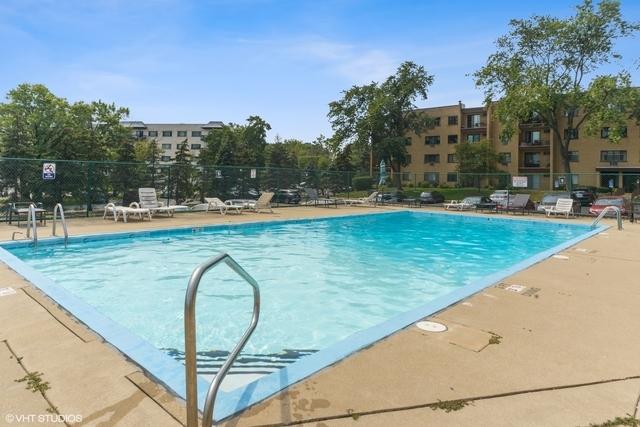 community pool featuring fence and a patio area