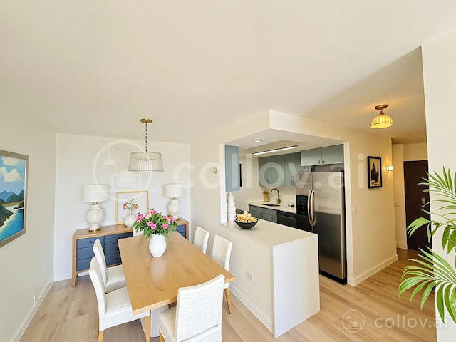 dining area with light wood-style flooring and baseboards