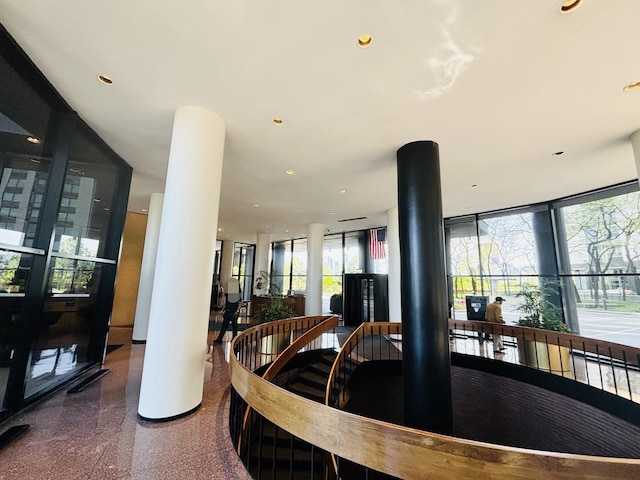 dining area featuring granite tiled floors, recessed lighting, and a wall of windows