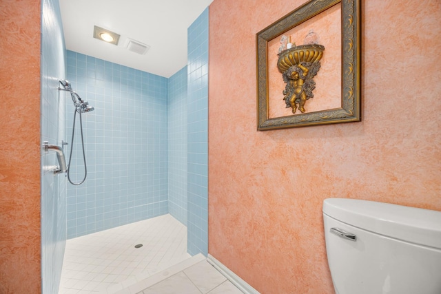 full bathroom featuring a stall shower, tile patterned flooring, and toilet