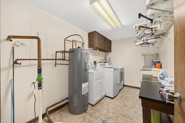 clothes washing area with washing machine and dryer, water heater, and cabinet space