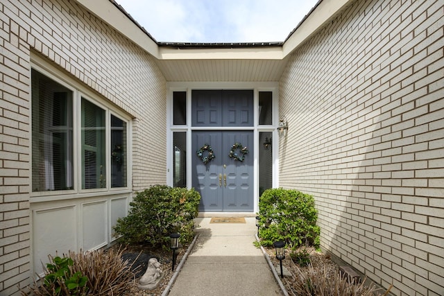 property entrance with brick siding