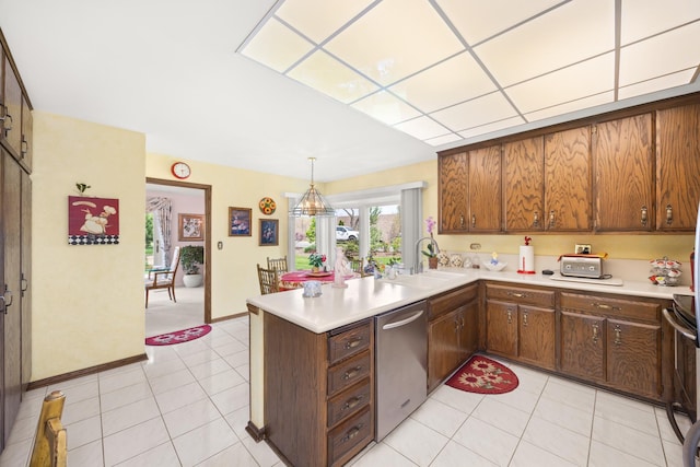 kitchen featuring a sink, stainless steel dishwasher, a peninsula, and light countertops
