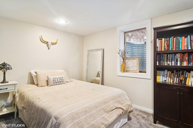 bedroom featuring baseboards and carpet flooring